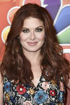 Debra Messing con cabello ondulado y smokey eye